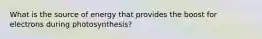 What is the source of energy that provides the boost for electrons during photosynthesis?