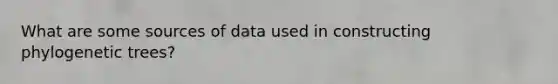 What are some sources of data used in constructing phylogenetic trees?