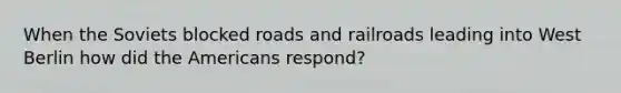 When the Soviets blocked roads and railroads leading into West Berlin how did the Americans respond?