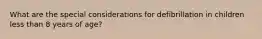 What are the special considerations for defibrillation in children less than 8 years of age?