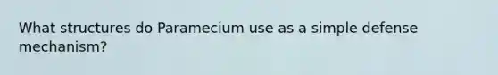 What structures do Paramecium use as a simple defense mechanism?