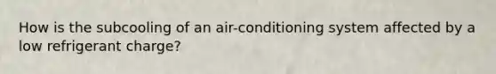 How is the subcooling of an air-conditioning system affected by a low refrigerant charge?