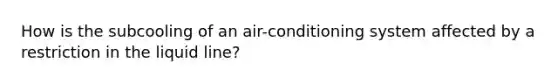 How is the subcooling of an air-conditioning system affected by a restriction in the liquid line?