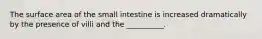 The surface area of the small intestine is increased dramatically by the presence of villi and the __________.