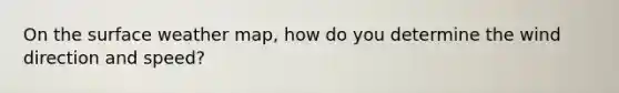 On the surface weather map, how do you determine the wind direction and speed?