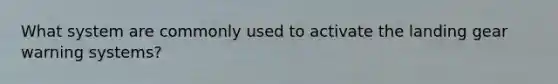 What system are commonly used to activate the landing gear warning systems?