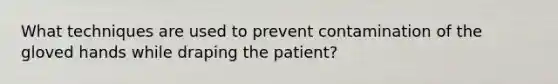 What techniques are used to prevent contamination of the gloved hands while draping the patient?