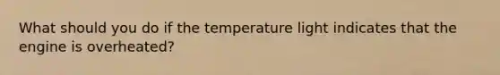 What should you do if the temperature light indicates that the engine is overheated?