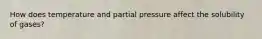 How does temperature and partial pressure affect the solubility of gases?