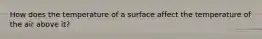 How does the temperature of a surface affect the temperature of the air above it?