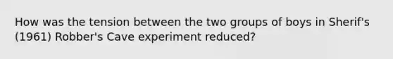 How was the tension between the two groups of boys in Sherif's (1961) Robber's Cave experiment reduced?