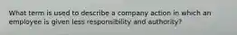 What term is used to describe a company action in which an employee is given less responsibility and authority?