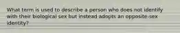 What term is used to describe a person who does not identify with their biological sex but instead adopts an opposite-sex identity?