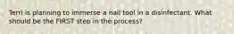 Terri is planning to immerse a nail tool in a disinfectant. What should be the FIRST step in the process?