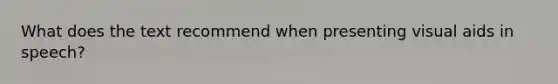 What does the text recommend when presenting visual aids in speech?