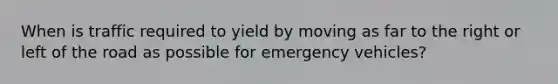 When is traffic required to yield by moving as far to the right or left of the road as possible for emergency vehicles?