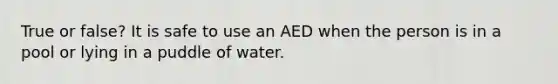 True or false? It is safe to use an AED when the person is in a pool or lying in a puddle of water.