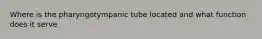 Where is the pharyngotympanic tube located and what function does it serve