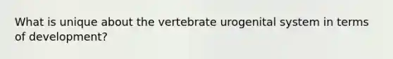 What is unique about the vertebrate urogenital system in terms of development?