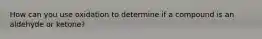 How can you use oxidation to determine if a compound is an aldehyde or ketone?