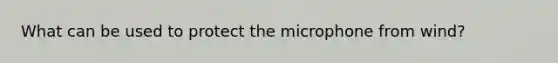 What can be used to protect the microphone from wind?