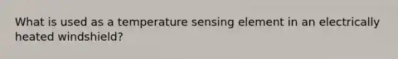 What is used as a temperature sensing element in an electrically heated windshield?