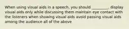 When using visual aids in a speech, you should _________. display visual aids only while discussing them maintain eye contact with the listeners when showing visual aids avoid passing visual aids among the audience all of the above