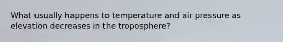 What usually happens to temperature and air pressure as elevation decreases in the troposphere?