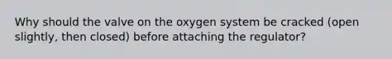 Why should the valve on the oxygen system be cracked (open slightly, then closed) before attaching the regulator?