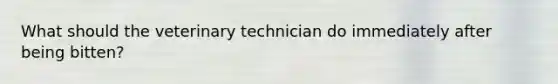 What should the veterinary technician do immediately after being bitten?