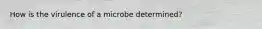 How is the virulence of a microbe determined?