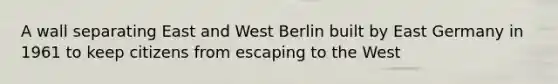 A wall separating East and West Berlin built by East Germany in 1961 to keep citizens from escaping to the West