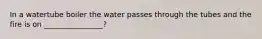 In a watertube boiler the water passes through the tubes and the fire is on ________________?