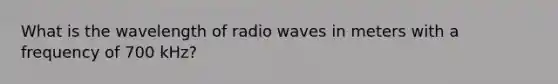 What is the wavelength of radio waves in meters with a frequency of 700 kHz?