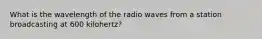 What is the wavelength of the radio waves from a station broadcasting at 600 kilohertz?