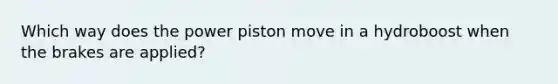 Which way does the power piston move in a hydroboost when the brakes are applied?