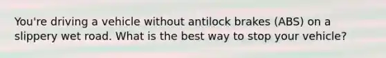 You're driving a vehicle without antilock brakes (ABS) on a slippery wet road. What is the best way to stop your vehicle?