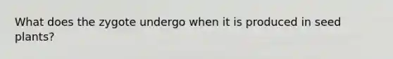 What does the zygote undergo when it is produced in seed plants?